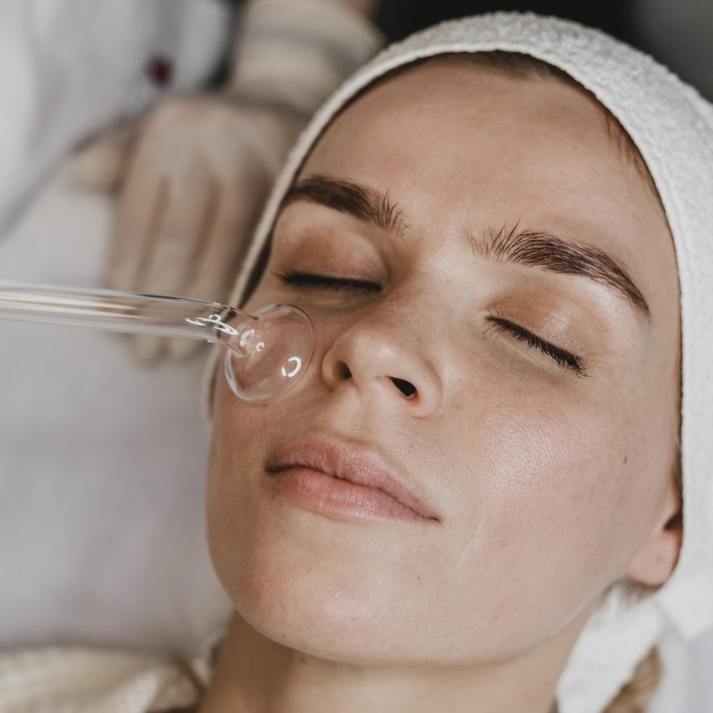 woman getting facial skin treatment wellness center woman getting facial skin treatment wellness center